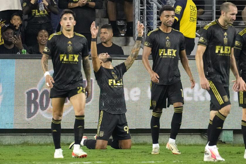 Los Angeles FC forward Denis Bouanga, second from left, celebrates his third goal during the first half of a Major League Soccer match against Minnesota United on Wednesday, Oct. 4, 2023, in Los Angeles. (AP Photo/Mark J. Terrill)