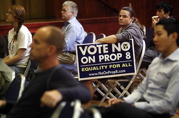West Hollywood resident Kenneth Armenta, 33, who is holding a sign, is among those watching the televised California Supreme Court hearing on Proposition 8 at the West Hollywood Auditorium. "I hope they overturn it," Armenta said.