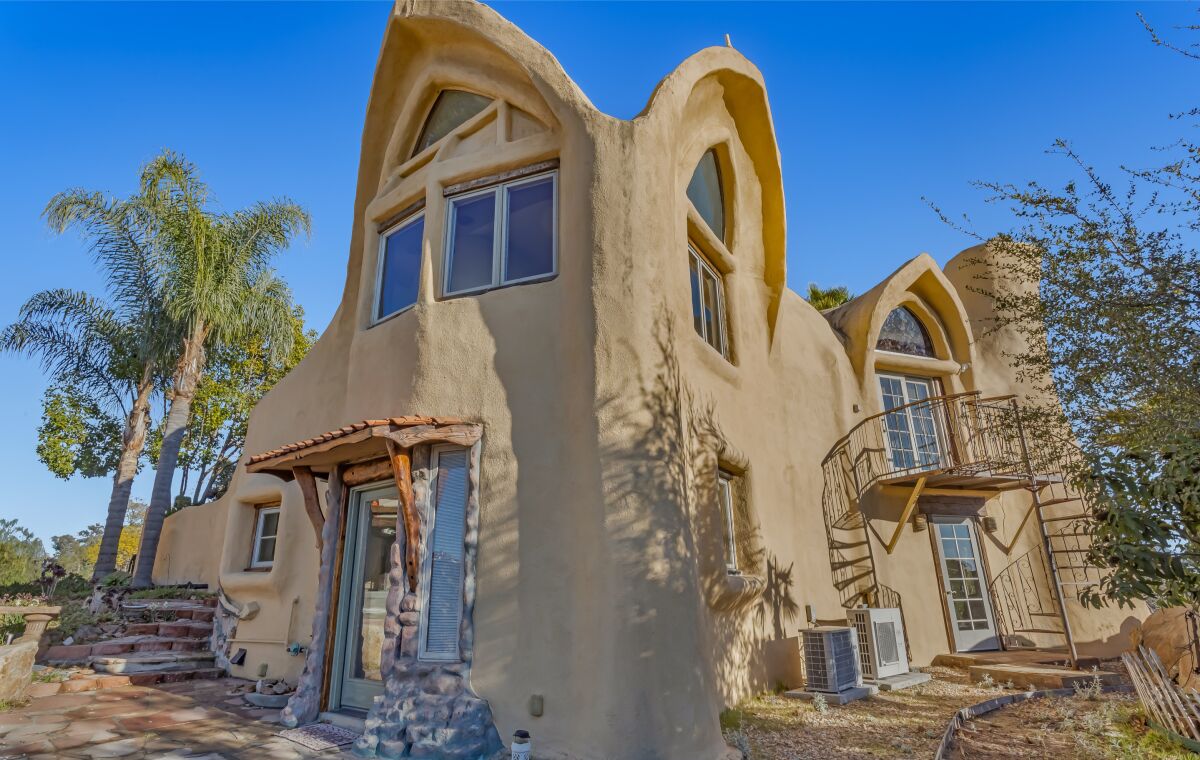 A cave-like home built to blend in with the rock-laden hills that surround it.