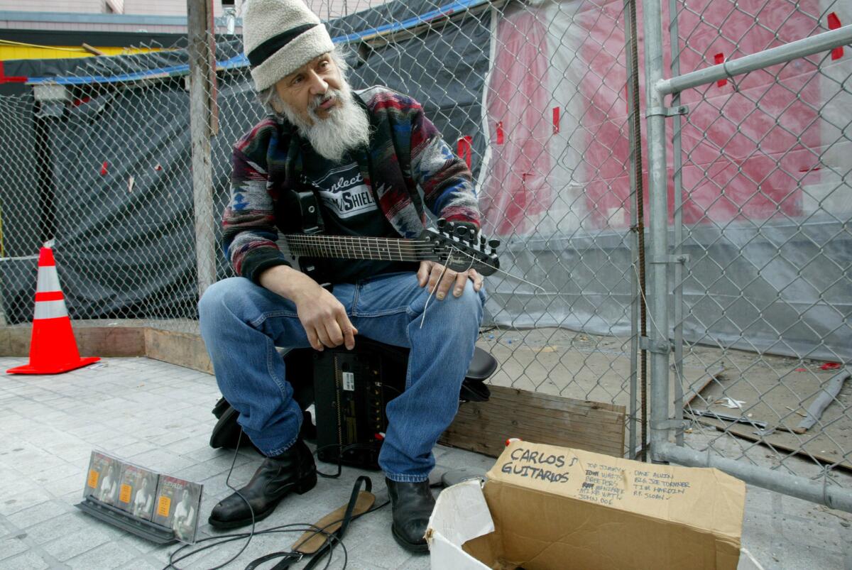 Carlos Guitarlos plays at a BART station in San Francisco on April 15, 2003.