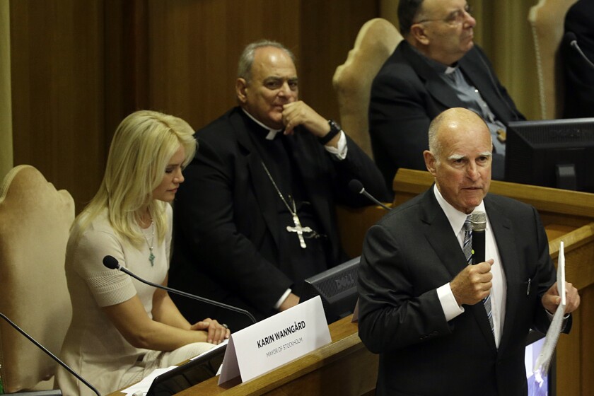 Gov. Jerry Brown delivers his speech in the Synod Hall as he attends a conference on climate change and modern slavery at the Vatican on Tuesday. Brown joined dozens of mayors from around the world at a meeting with Pope Francis to discuss reducing global warming and helping the urban poor deal with its effects.