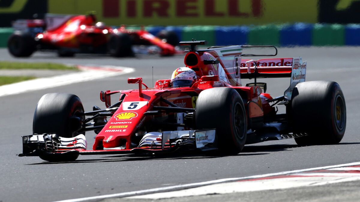 Formula One driver Sebastian Vettel leads Ferrari teammate Kimi Raikkonen through a turn during the Hungarian Grand Prix on Sunday.