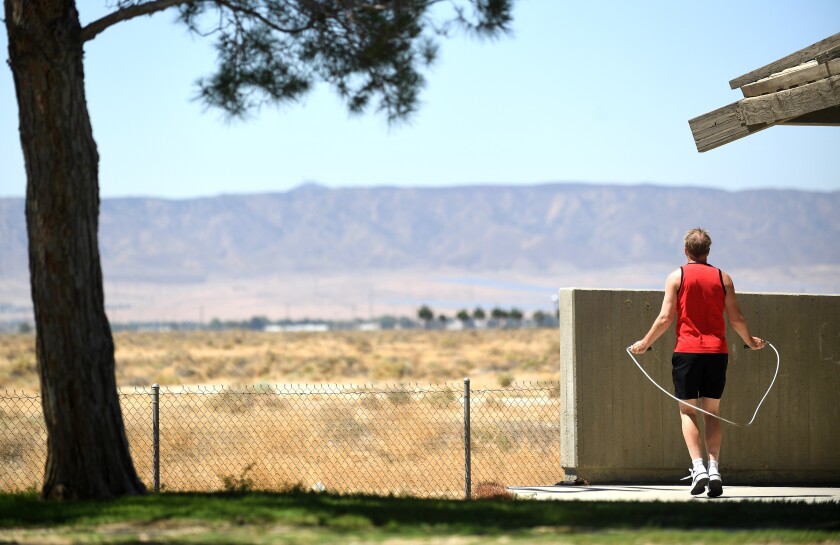 A man jumps rope outside.