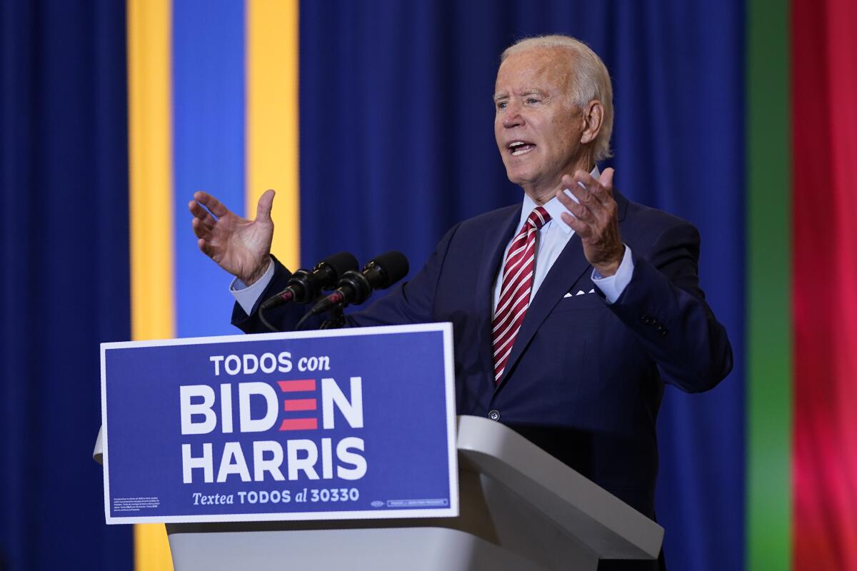Joe Biden at a lectern labeled "Todos con Biden Harris"