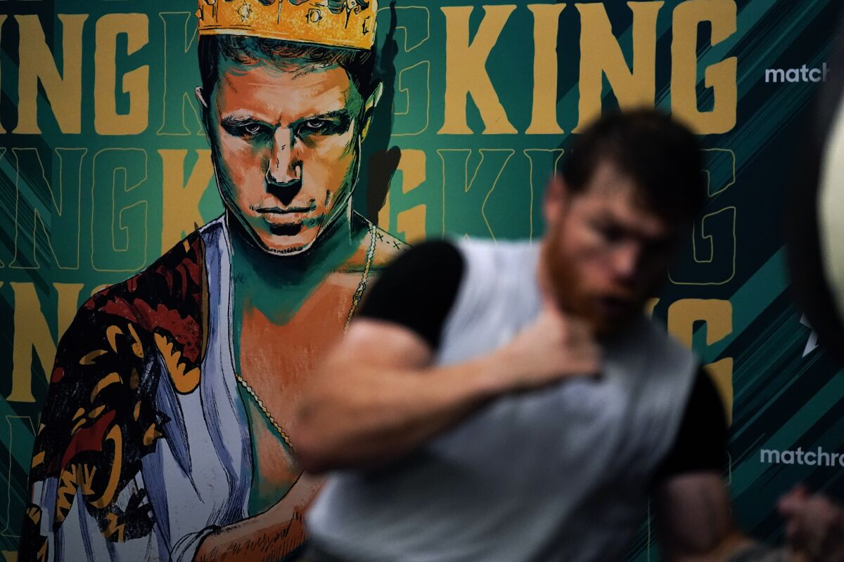 Unified WBC/WBO/WBA super middleweight champion Canelo Álvarez trains in front of an image of himself at a gym in San Diego