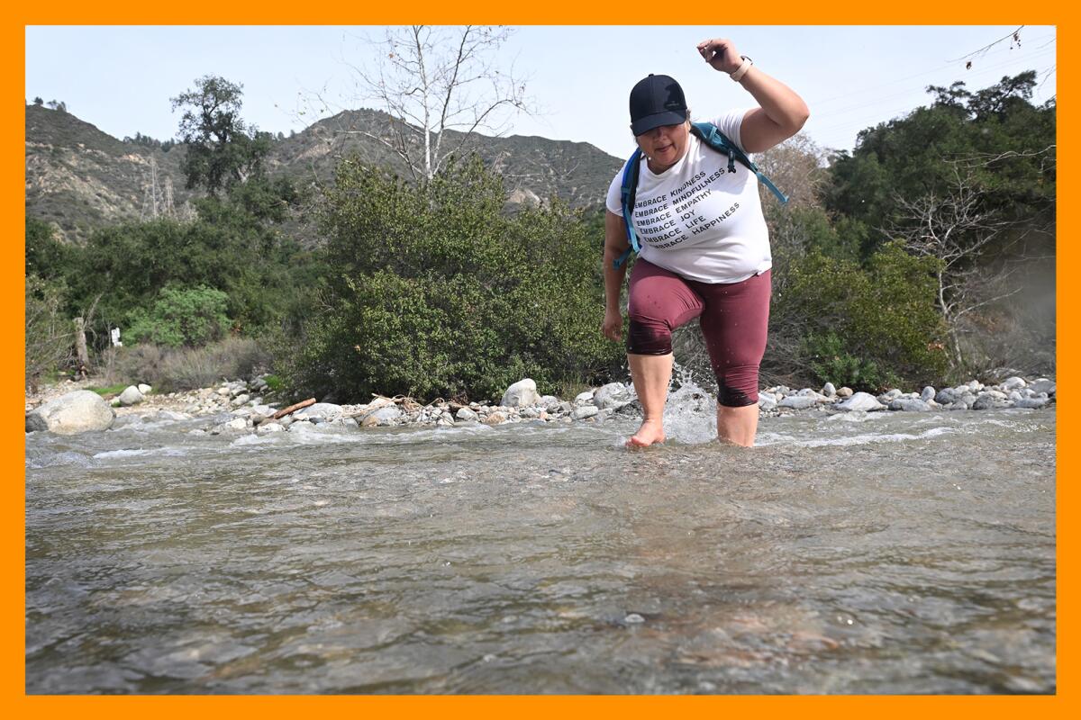 A person navigates a creek in Eaton Canyon.