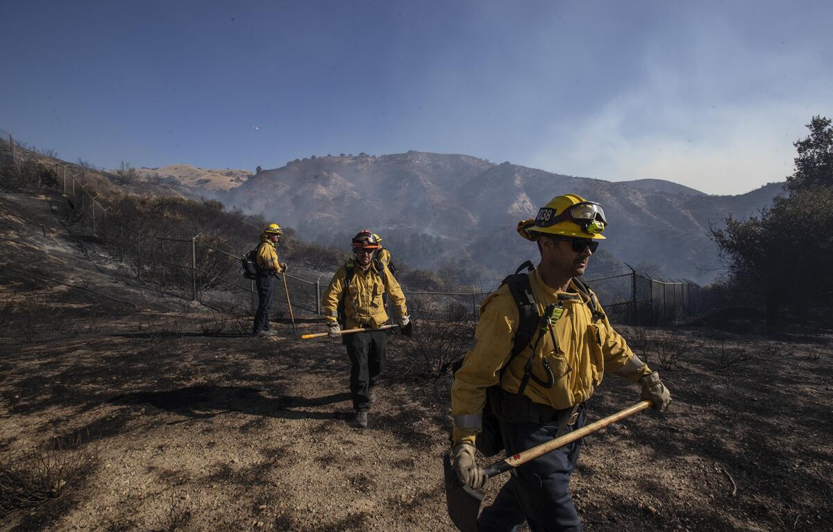 Fire crews head out to clear brush around homes in Porter Ranch