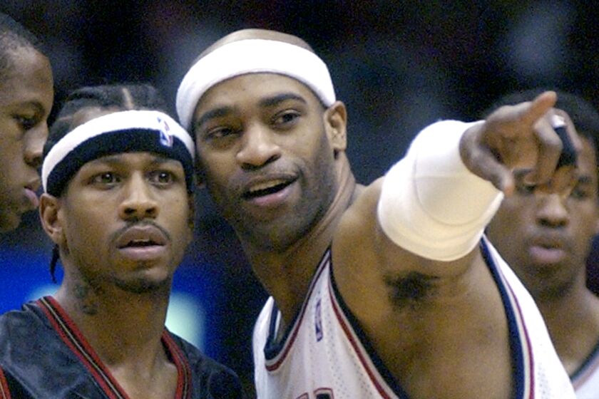 New Jersey Nets forward Vince Carter, right, points out someone to Philadelphia 76ers' Allen Iverson before a game in April 2005.