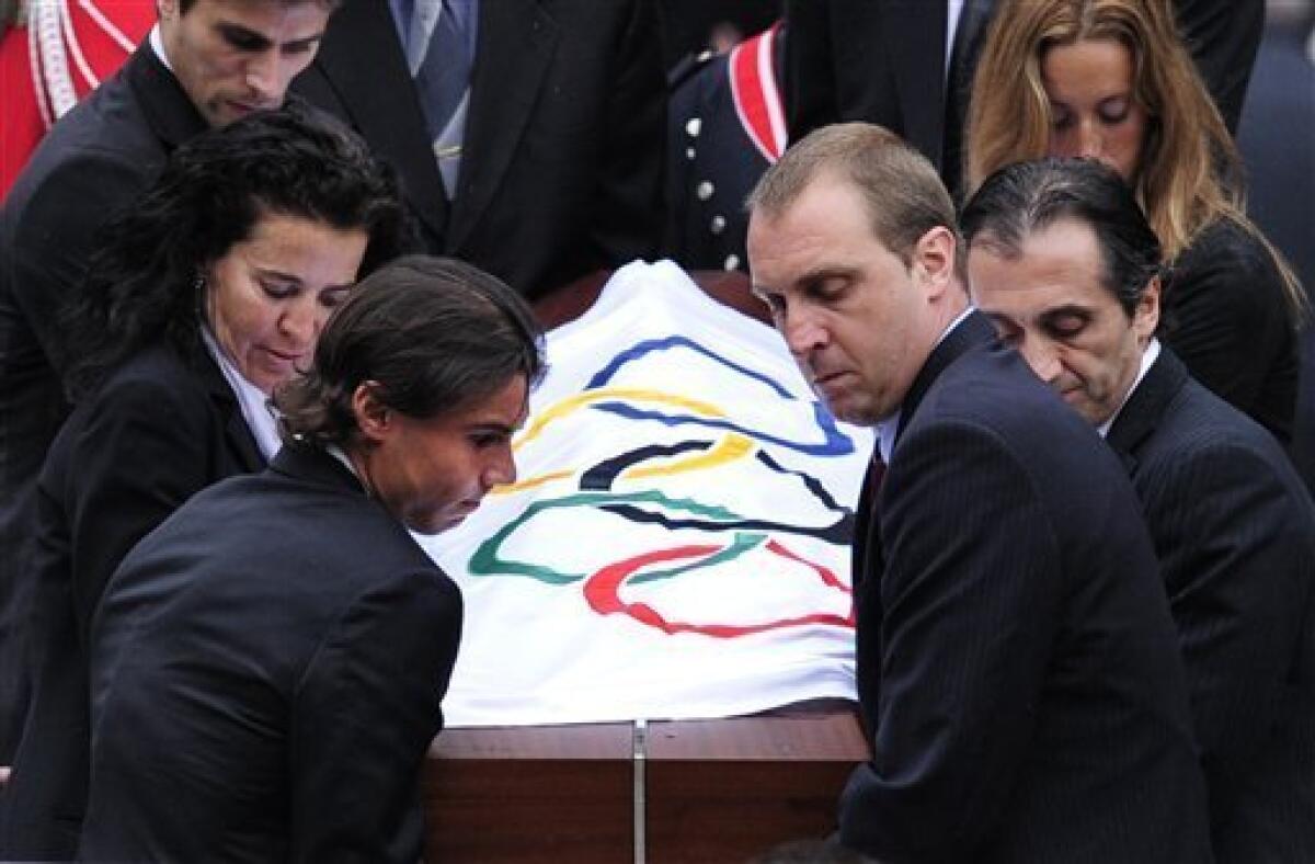 The coffin of the late former International Olympic Committee president Juan Antonio Samaranch is carried by Spanish athletes as it leaves the cathedral during his funeral in Barcelona, Spain, on Thursday, April 22, 2010. Samaranch died Wednesday at age 89 in the Quiron Hospital in his home city of Barcelona of cardio-respiratory failure three days after being admitted with heart problems. (AP Photo/David Ramos)