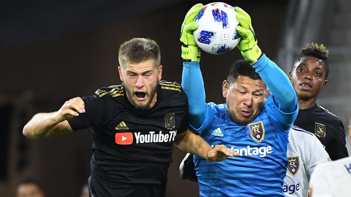 LAFC's Walker Zimmerman tries to head the ball into the net, but Real Salt Lake goalie Nick Rimando makes a save during the team's playoff game last season. Zimmerman said that season-ending loss left "a bitter taste in our mouth."