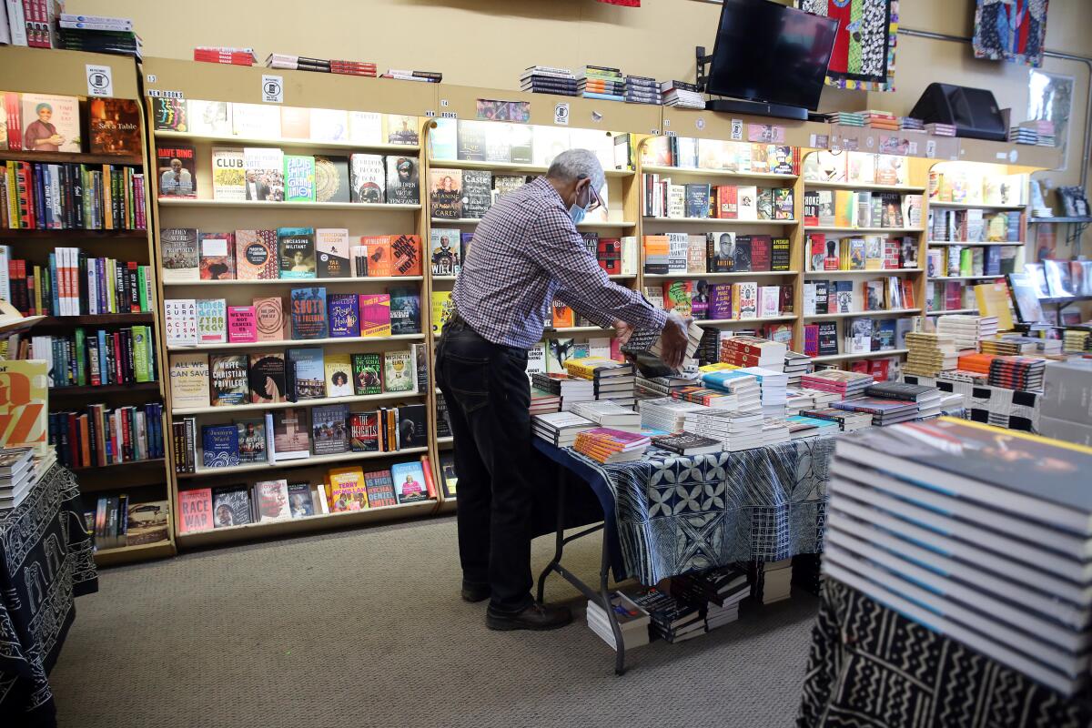 Store co-owner James Fugate organizes the books at Eso Won.