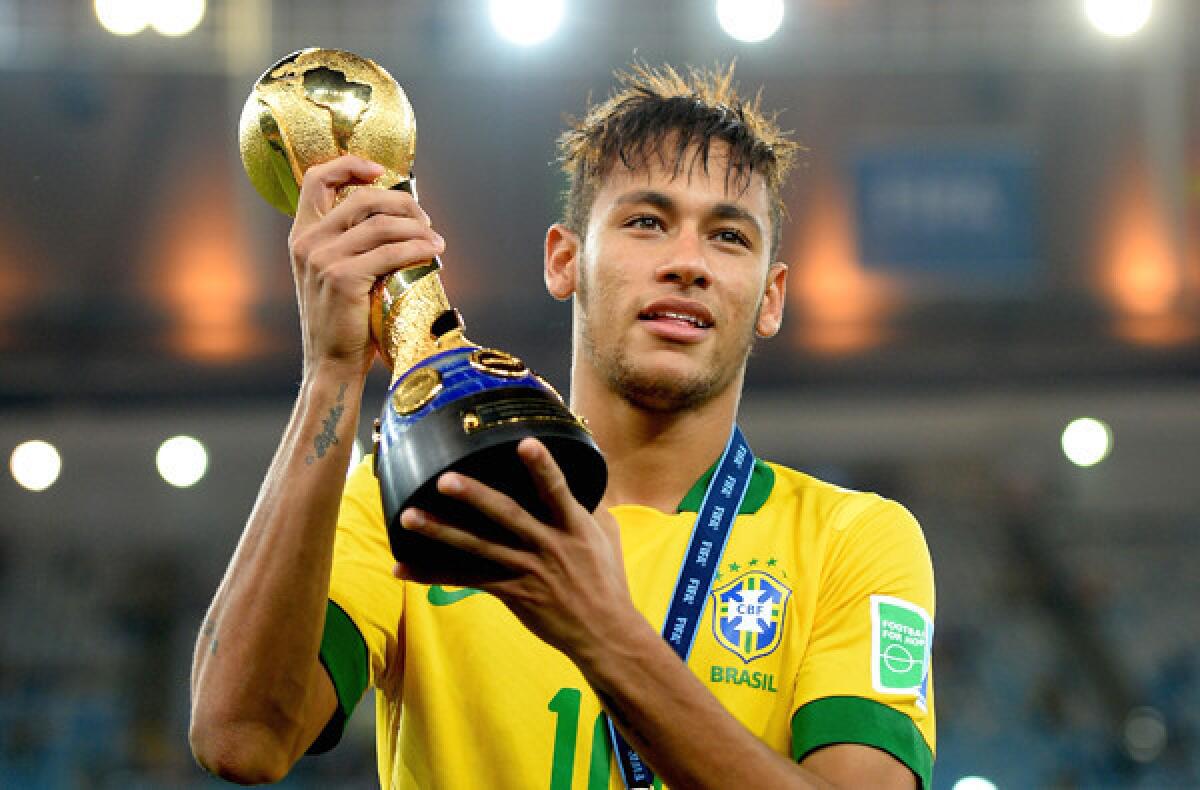 Neymar holds aloft of the winner's trophy after Brazil defeated Spain, 3-0, in the FIFA Confederations Cup final.