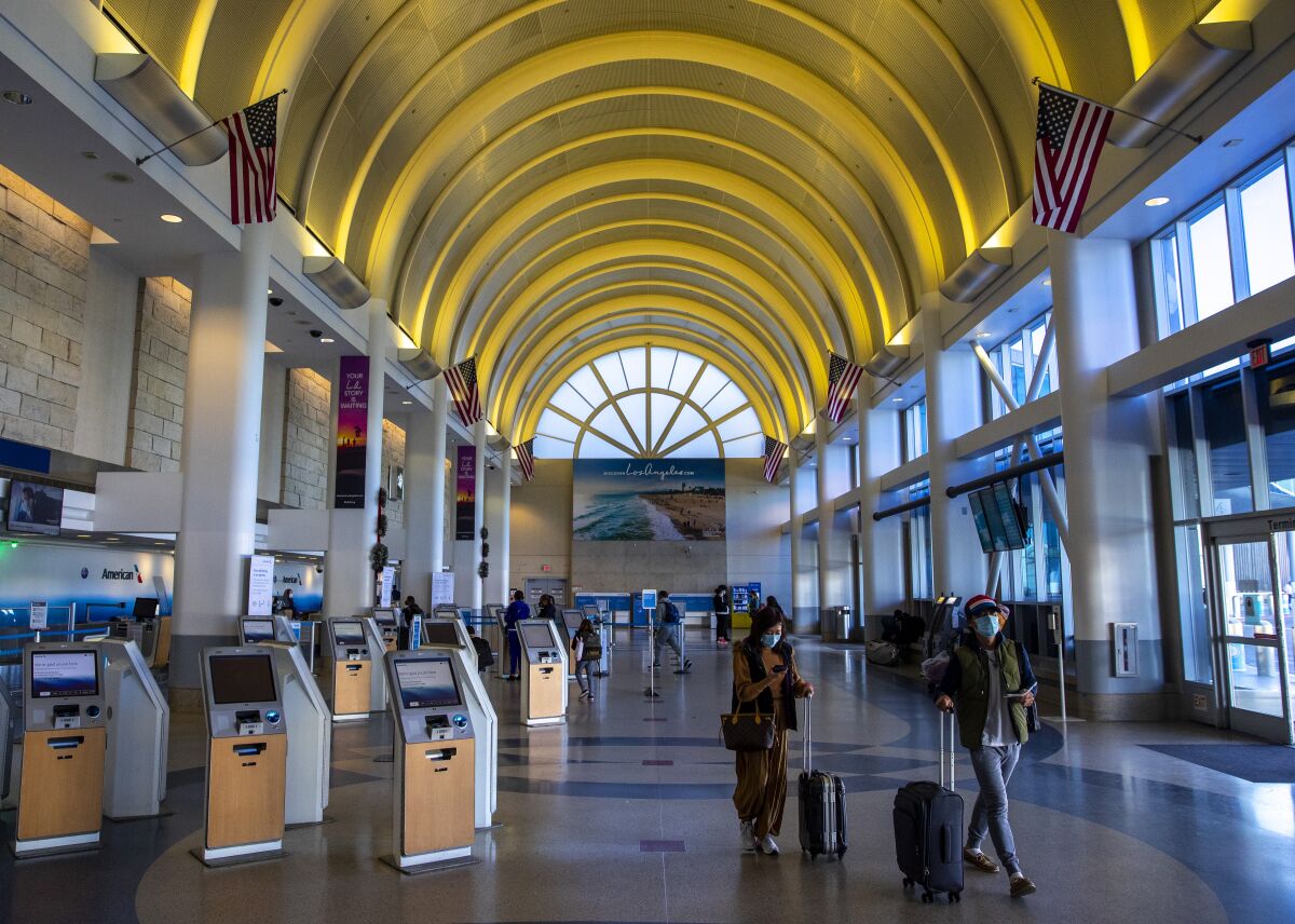 Travelers walk inside Terminal 4 at Los Angeles International Airport on Dec. 31.