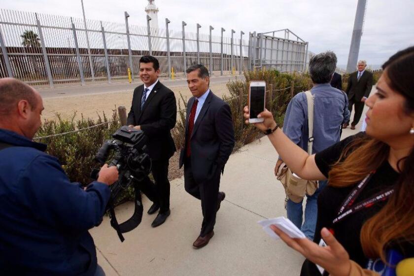 San Diego, Ca September 20, 2017: Chula Vista Councilmember David Alvarez , left, and Atty. Gen. Xavier Becerra, right, walk next to the boarder fence after a press conference in Border Field State Park in San Diego, Ca September 20, 2017. He is alleging the Trump administration failed to following Federal and State environmental law. (Francine Orr/ Los Angeles Times)