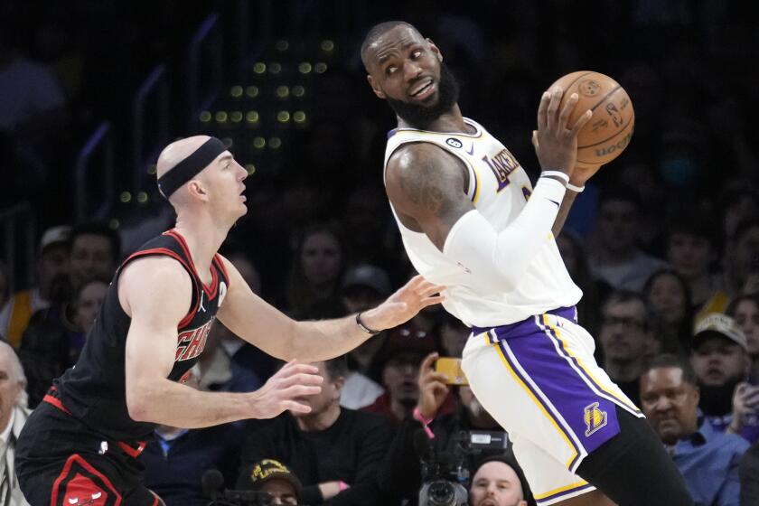 Los Angeles Lakers forward LeBron James, right, is defended by Chicago Bulls guard Alex Caruso.