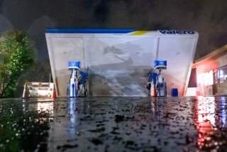 A damaged Valero gas station creaks in the wind during a massive "bomb cyclone" rain storm in South San Francisco, California on January 4, 2023. - A bomb cyclone smashed into California on January 4, 2023, bringing powerful winds and torrential rain that was expected to cause flooding in areas already saturated by consecutive storms. (Photo by JOSH EDELSON / AFP) (Photo by JOSH EDELSON/AFP via Getty Images)