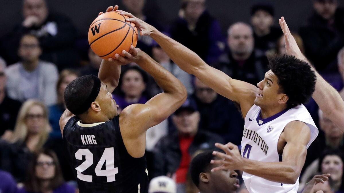 Washington's Matisse Thybulle, right, blocks a shot by Colorado's George King in the first half.