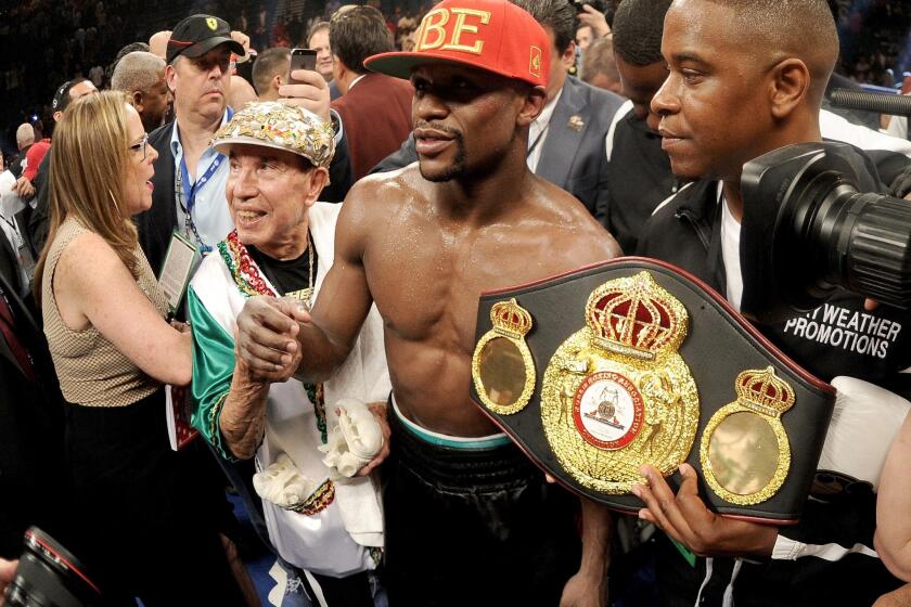 Floyd Mayweather Jr. celebrates after defeating Marcos Maidana by majority decision in their WBC/WBA welterweight unification fight.