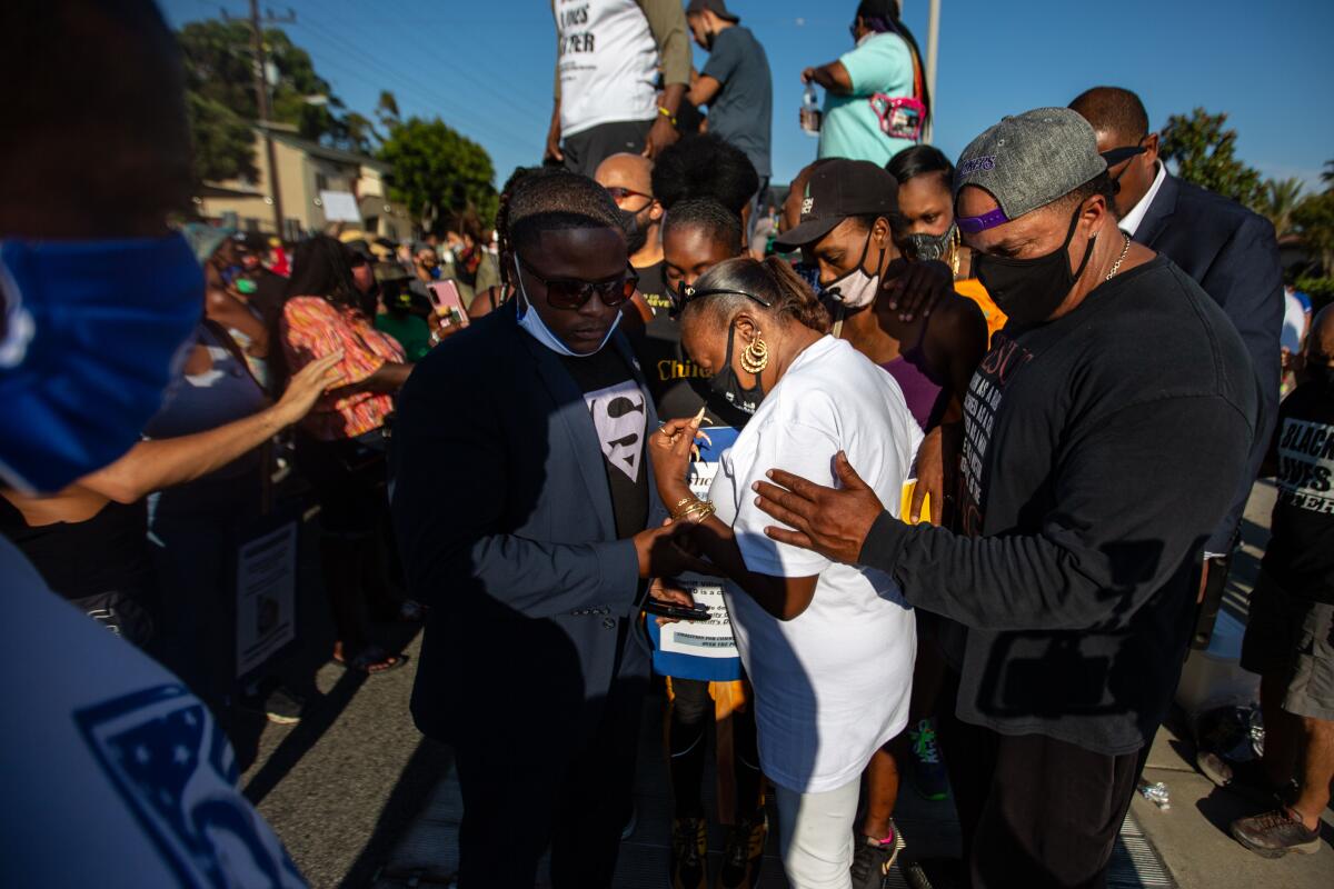 The family of Dijon Kizzee gather with protesters in front of the South Los Angeles Sheriff's station.
