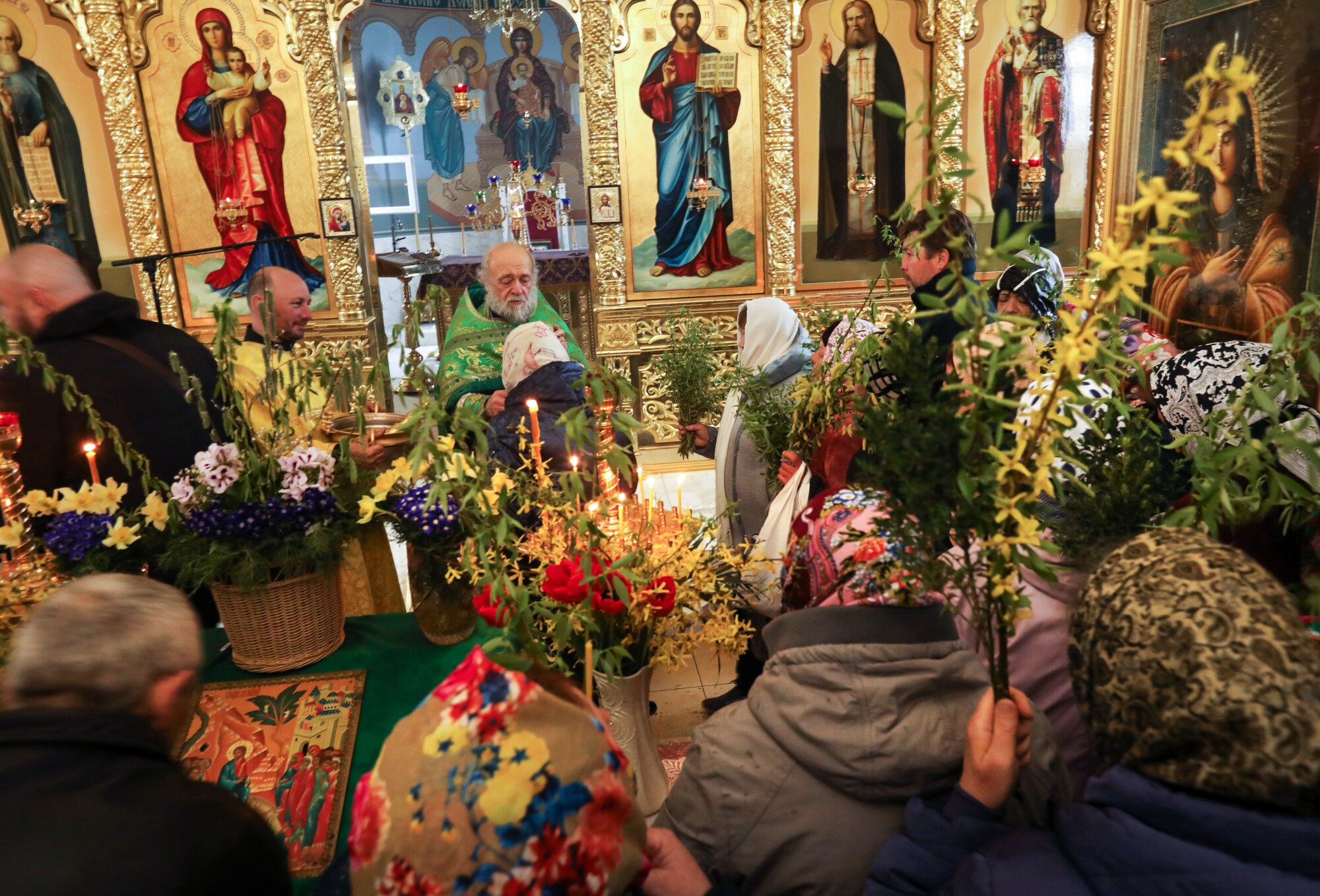 Father Valeri Lebed blesses those attending Palm Sunday service at the Serafim Sarovsky Orthodox Church