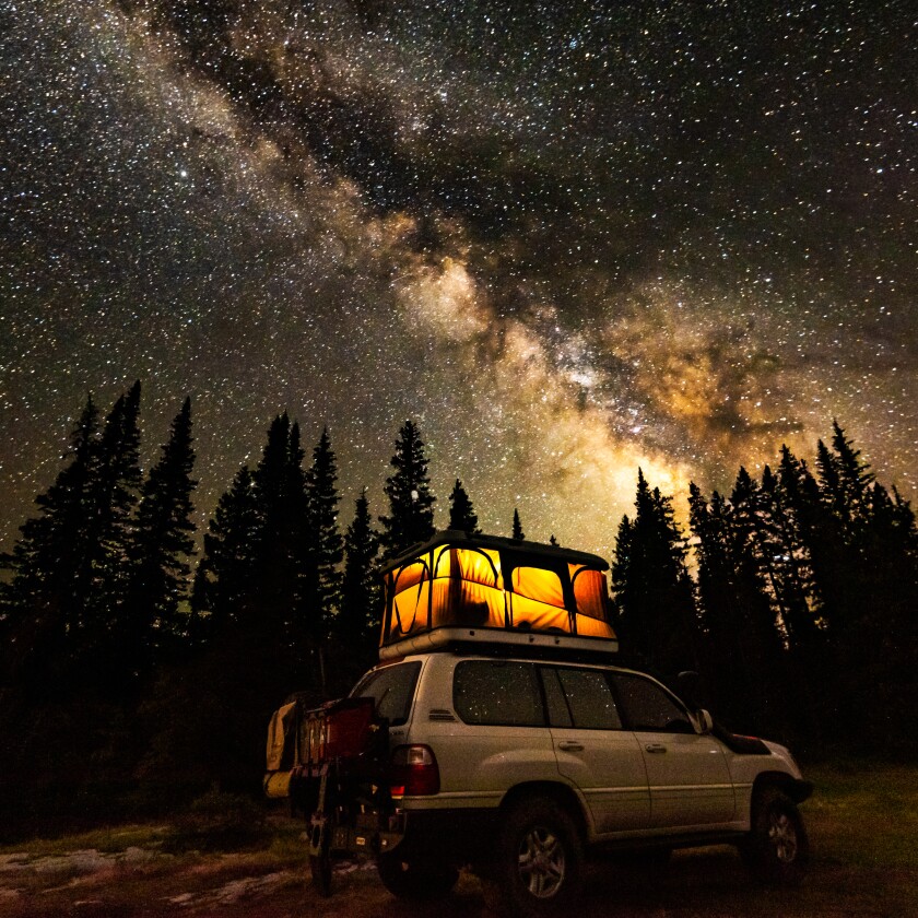 A van with the Milky Way overhead.