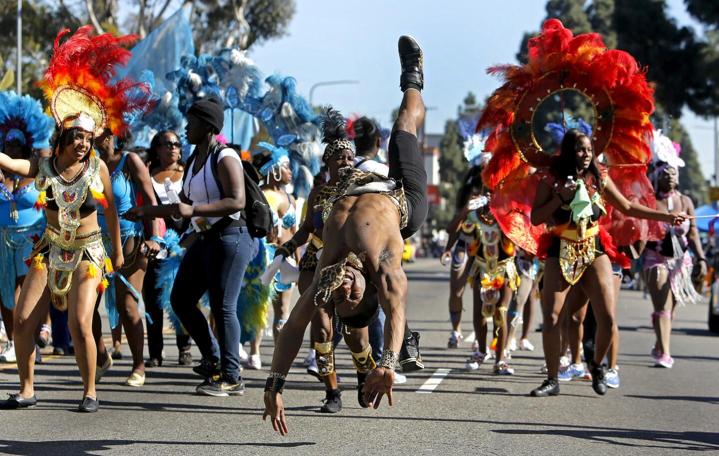 Thomas Morrison, center, performs with the Caribbean dance group Trinifeters at the 29th annual Kingdom Day Parade on Martin Luther King Blvd. in Los Angeles.