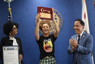 Grammy award nominated singer Andra Day holds up the key to the city as San Diego Mayor Todd Gloria and Councilmember Monica Montgomery Steppe look on Friday, July 2, 2021 in San Diego. (Photo/Denis Poroy)