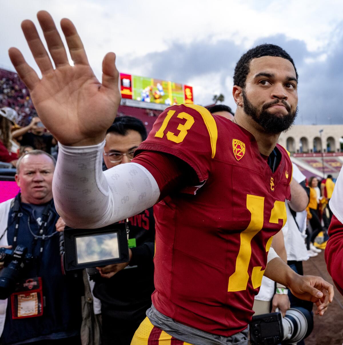 USC quarterback Caleb Williams waves to fans at the Coliseum as he leaves the field following a 38-20 loss to UCLA.
