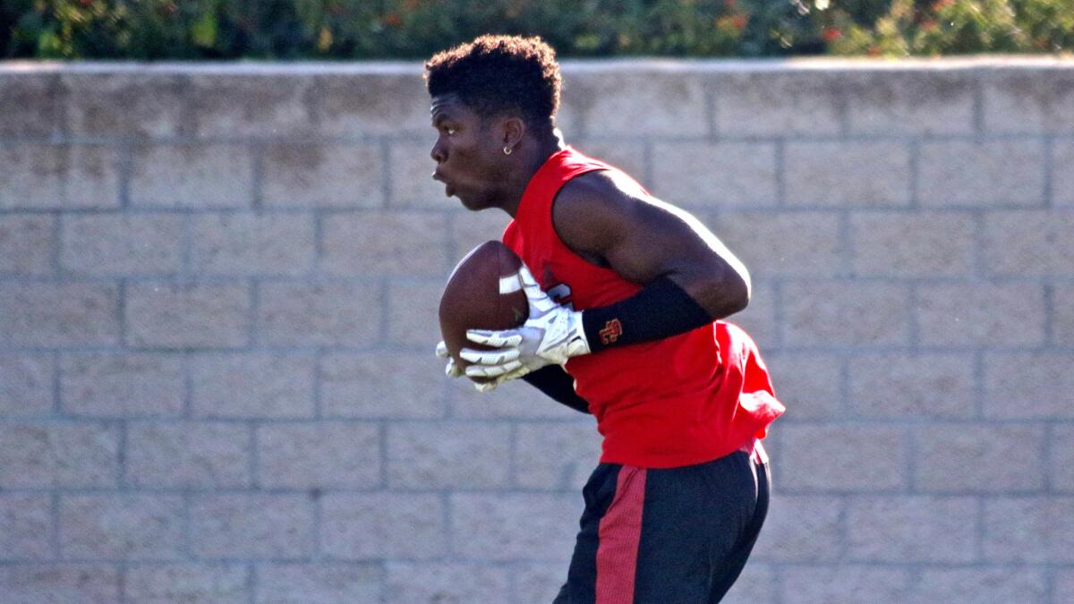 Summit running back Stephen Carr catches a pass during a B2G summer passing league event at Orange Coast College.