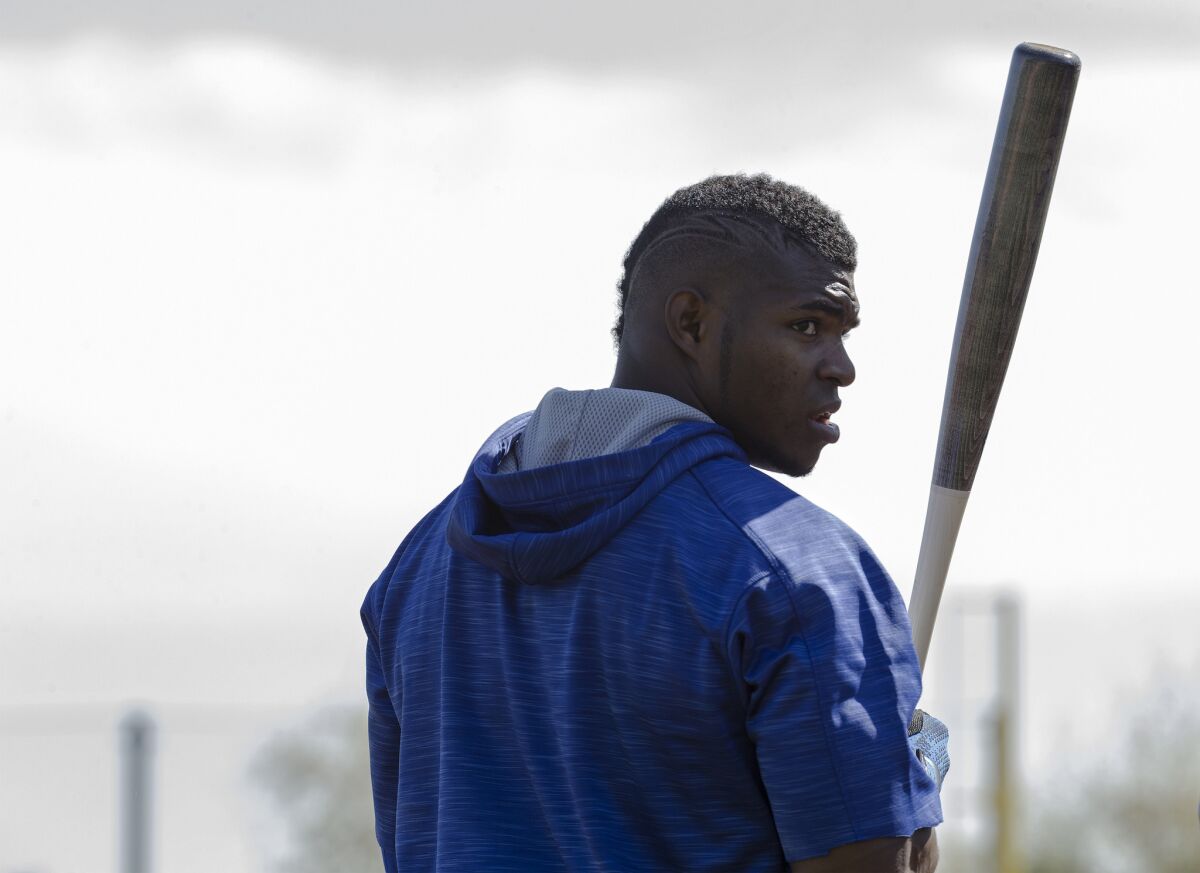 Dodgers outfielder Yasiel Puig looks back at cheering fans before taking batting practice during spring training at Camelback Ranch on Feb. 27