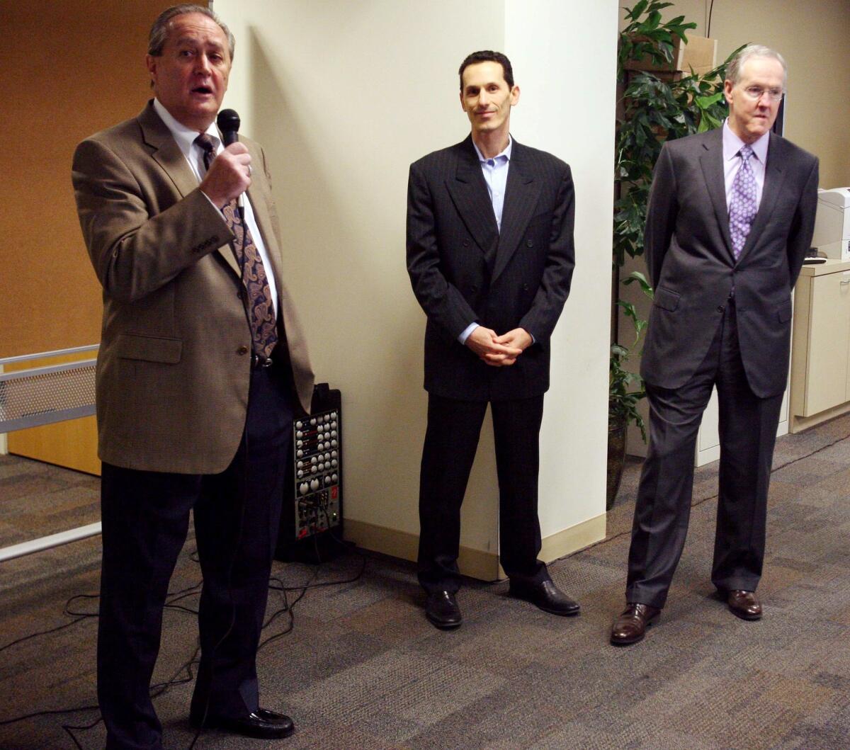 Riverside Press-Enterprise publisher Ron Redfern, left, Freedom Communications Chief Executive Aaron Kushner and A.H. Belo CEO Robert Decherd speak to employees about the newspaper's purchase.