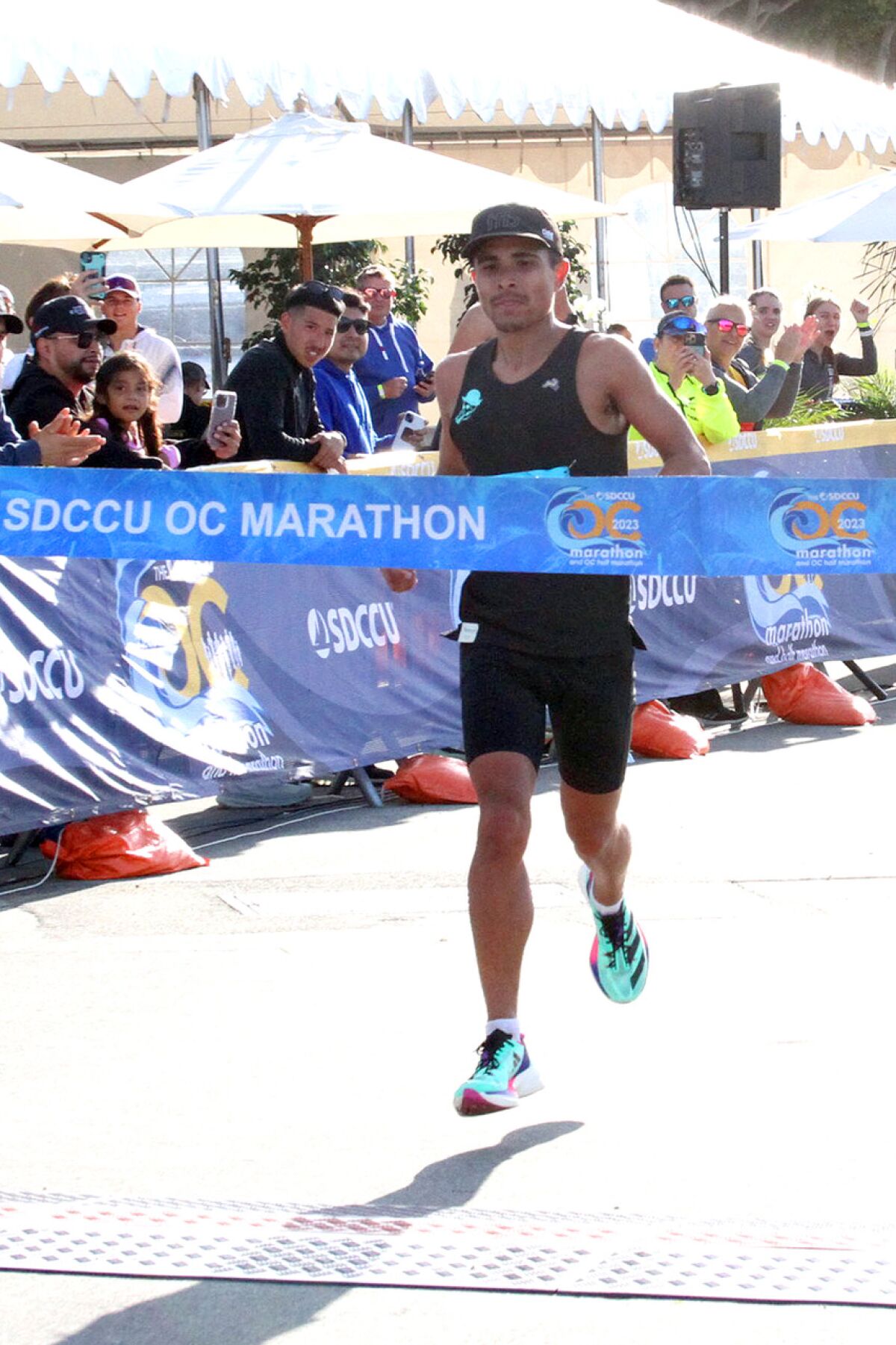 Steven Martinez of San Diego crosses the finish line at the SDCCU OC Marathon.