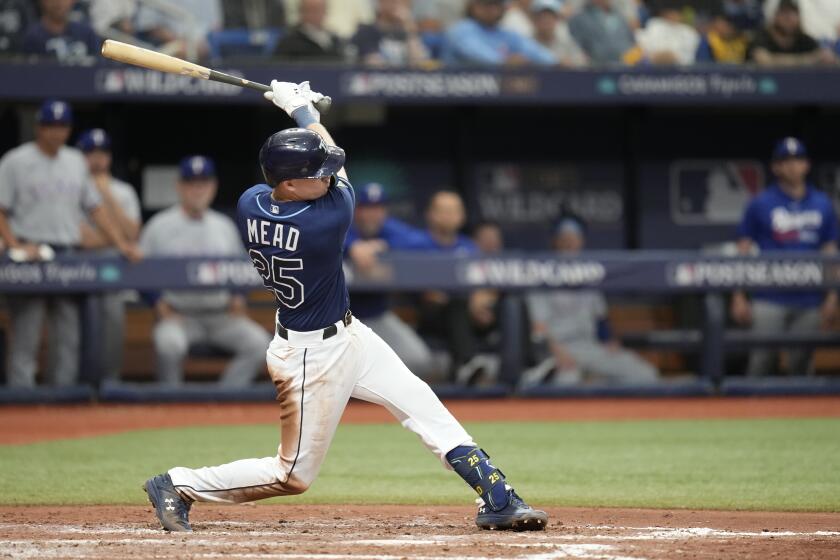 Tampa Bay Rays' Curtis Mead gets a base hit scoring Josh Lowe in the seventh inning during Game 2 in an AL wild-card baseball playoff series against the Texas Rangers, Wednesday, Oct. 4, 2023, in St. Petersburg, Fla. (AP Photo/John Raoux)