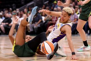 SEATTLE, WASHINGTON - JUNE 06: Layshia Clarendon #25 of the Los Angeles Sparks and Mercedes Russell #21 of the Seattle Storm dive for the ball during the first quarter at Climate Pledge Arena on June 06, 2023 in Seattle, Washington. (Photo by Steph Chambers/Getty Images)