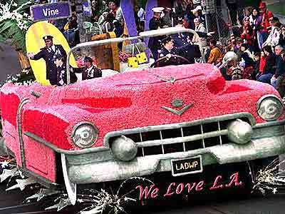 Members of New York's police and fire departments and Port Authority ride in city in Los Angeles' float, a giant pink Cadillac.
