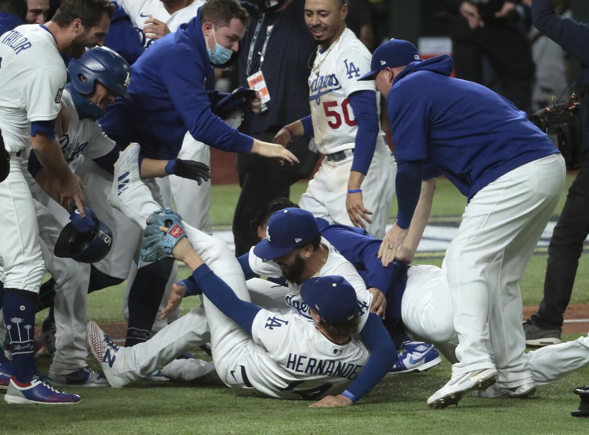 The Dodgers celebrate after clinching the World Series championship with a 3-1 win over the Tampa Bay Rays on Tuesday.