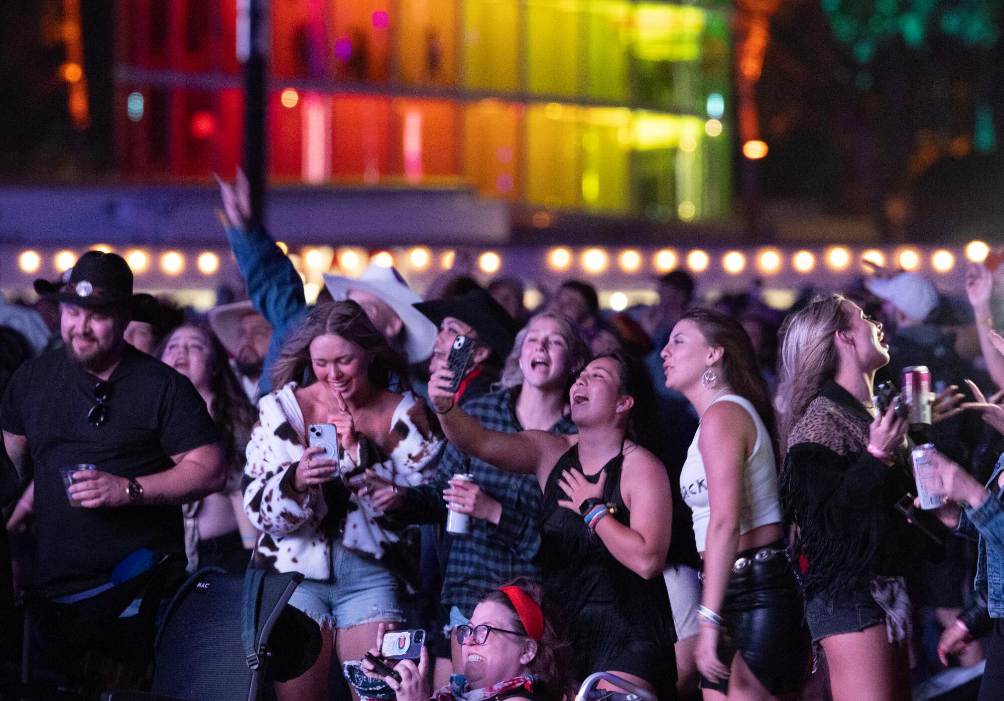 Fans dance and sing along as Jelly Roll performs at the Stagecoach Country Music Festival.