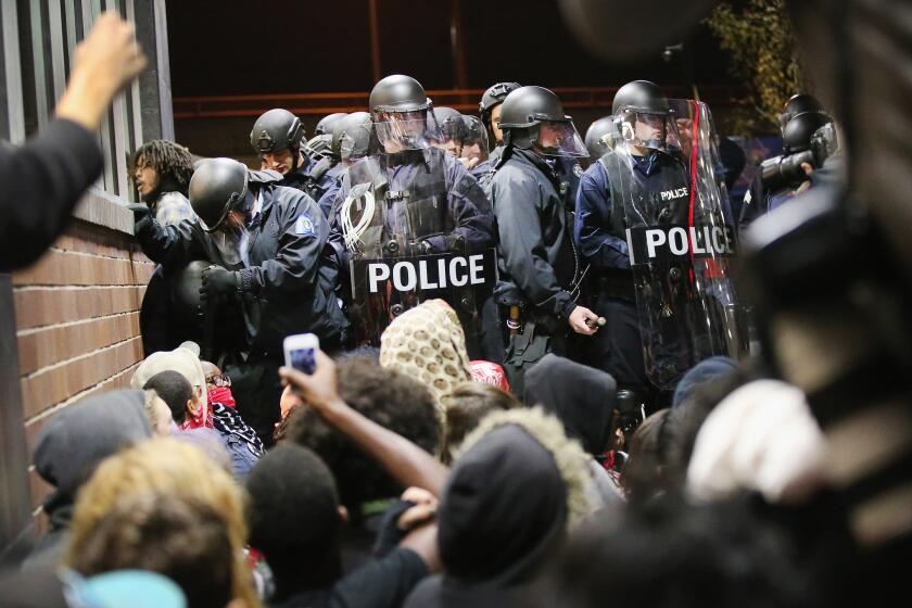 Ferguson, Mo., police confront protesters after the death of 18-year-old Michael Brown. The U.S. Department of Justice report on the Ferguson Police Department will come to bookstores this summer.