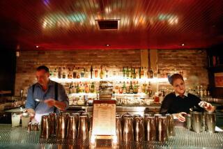 LOS ANGELES, CA - FEBRUARY 27, 2015 -- Bartenders Jason Hubert, left, and Mikki Kristola work up drinks for customers at The Varnish which is located to the rear of Cole's restaurant in downtown Los Angeles on February 27, 2015. (Genaro Molina/Los Angeles Times)