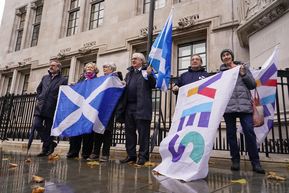Demonstrators hold Scottish flags outside the Supreme Court in London.