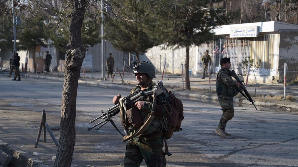 Afghan National Army soldiers keep watch in front of the main gate of a military hospital March 8 in Kabul after a deadly six-hour attack claimed by Islamic State.