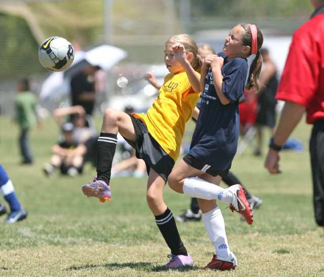 Carden Hall's Rachel Davis, yellow, and Tia Grippo of Pegasus, right, battle for runaway ball downfield in championship game action Sunday.