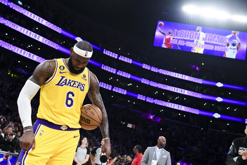 LeBron James reacts during a ceremony as he was honored for breaking the NBA scoring record