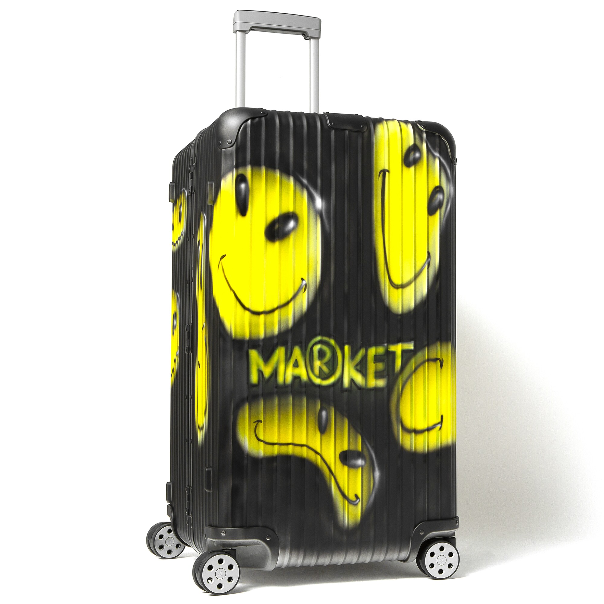 A black rolling suitcase with yellow smiley faces and the word "Market" on it
