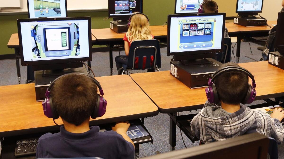 Students participate during a summer reading academy at Buchanan Elementary School in Oklahoma City in 2014. The California Department of Education this week released results from last spring's standardized tests, which students complete using computers.