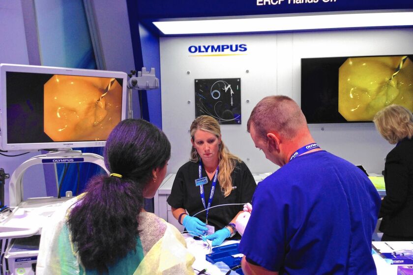 The Olympus exhibit space at the Digestive Disease Week conference in Washington draws a steady stream of doctors from around the world.