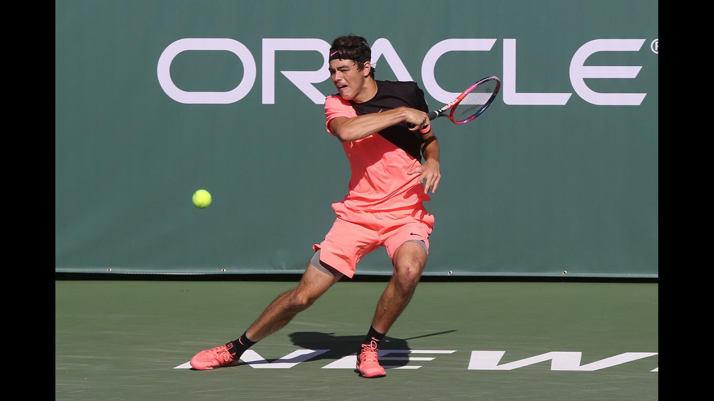 Taylor Fritz makes a forehand return in his match against Noah Rubin during the Oracle Challenger Series at the Newport Beach Tennis Club on Friday.