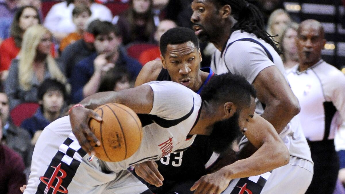 Rockets guard James Harden drives against Clippers forward Wesley Johnson during the first half Friday