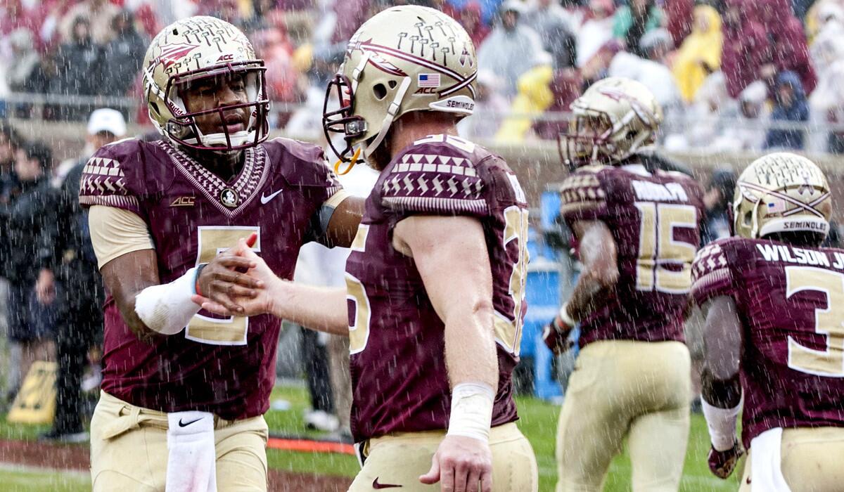 Florida State quarterback Jameis Winston, left, congratulates tight end Nick O'Leary after the two connected for a touchdown against Boston College on Saturday.