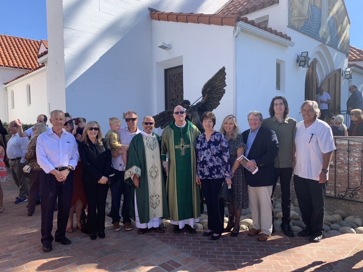 Family of Adm. William Walsh and staff of Mary, Star of the Sea church attend the dedication of a monument to St. Michael.
